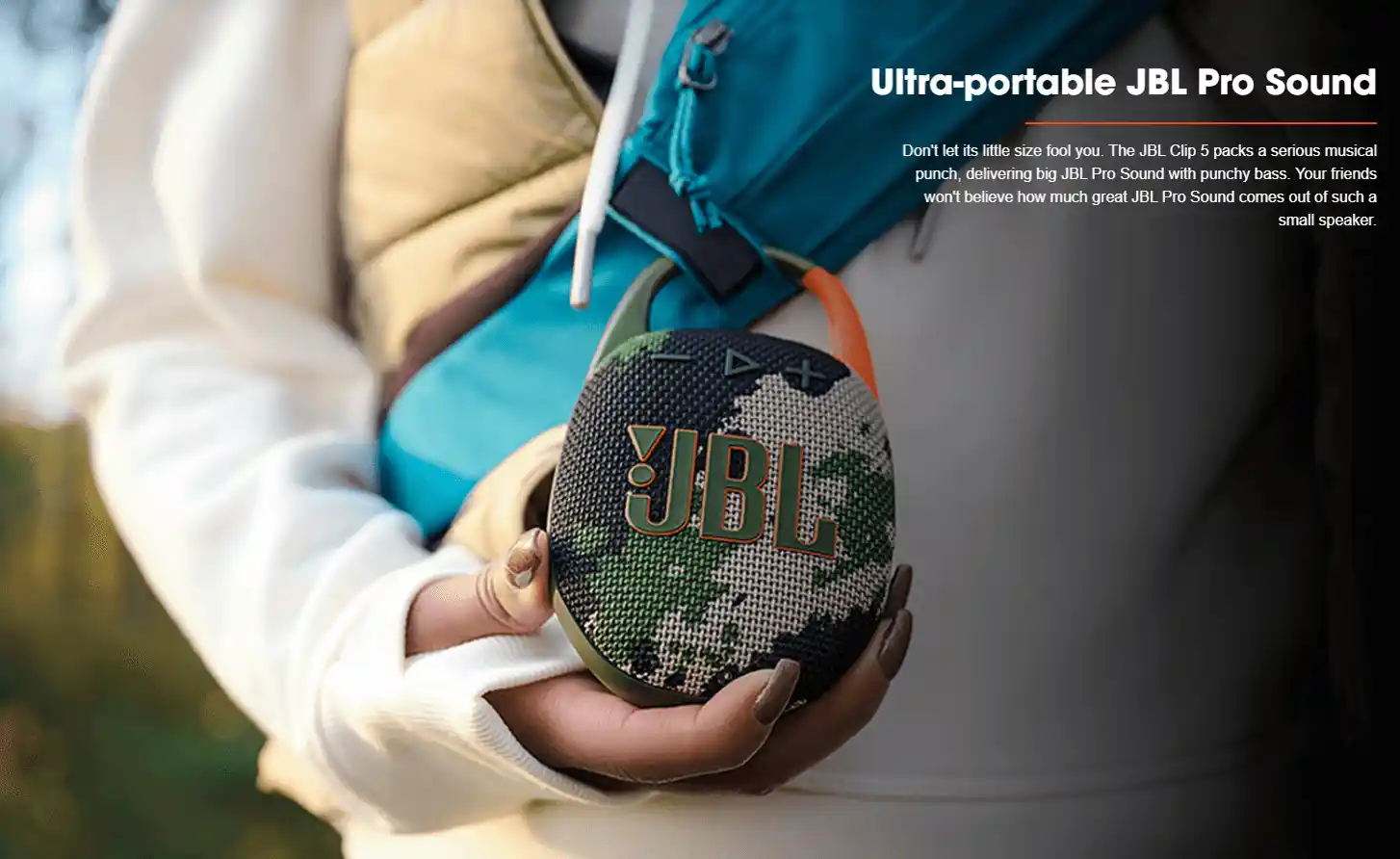 Bluetooth speaker hanging on a backpack